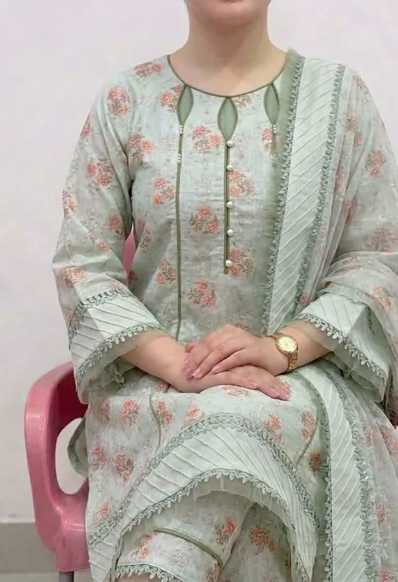 A printed mint suit with white trim, made at MZ Tailors & Boutique